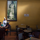 A waiter serves schoolgirls beneath a portrait of Rabindranath Tagore in the Indian Coffee House, Kolkata, India.